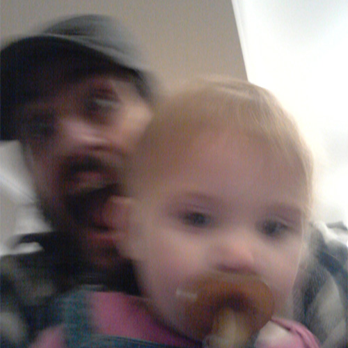 Blurry photo of man holding a child (Bob Wiseman)