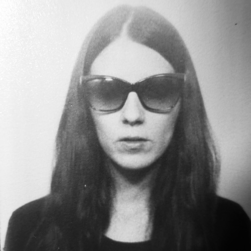 Black and white photo of woman with glasses, looking at the camera (crys cole)