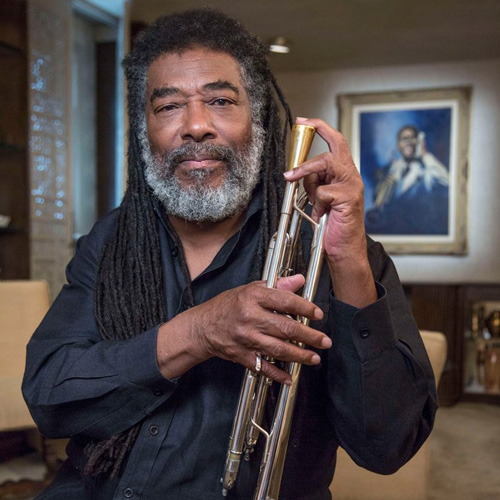 Photo of a man holding a brass instrument, looking at the camera (Wadada Leo Smith)